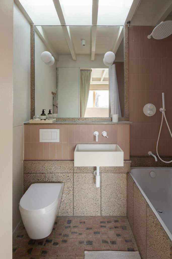 a room with a sink and a mirror
