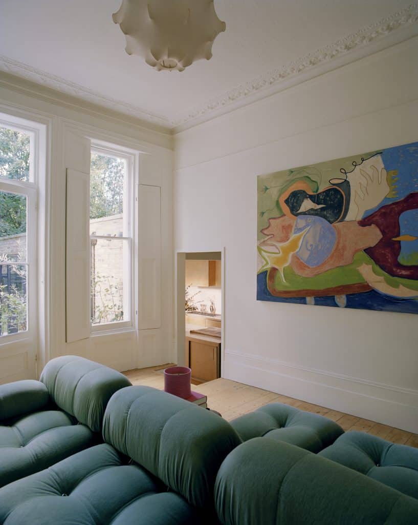 a living room filled with furniture and a large window