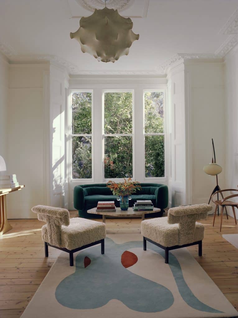 a living room filled with furniture and a large window
