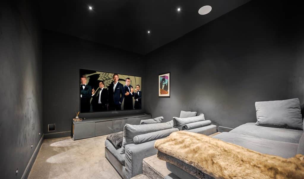 a flat screen tv sitting on top of a bed