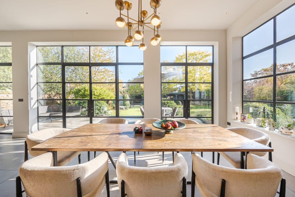 an island in the middle of a living room with a large window