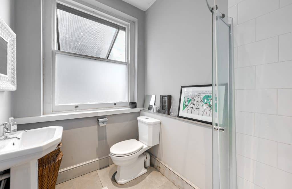 a restroom with a sink and a window