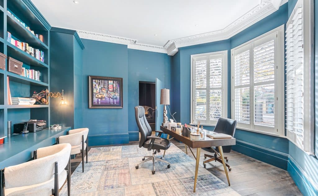 a living room filled with furniture and a large window