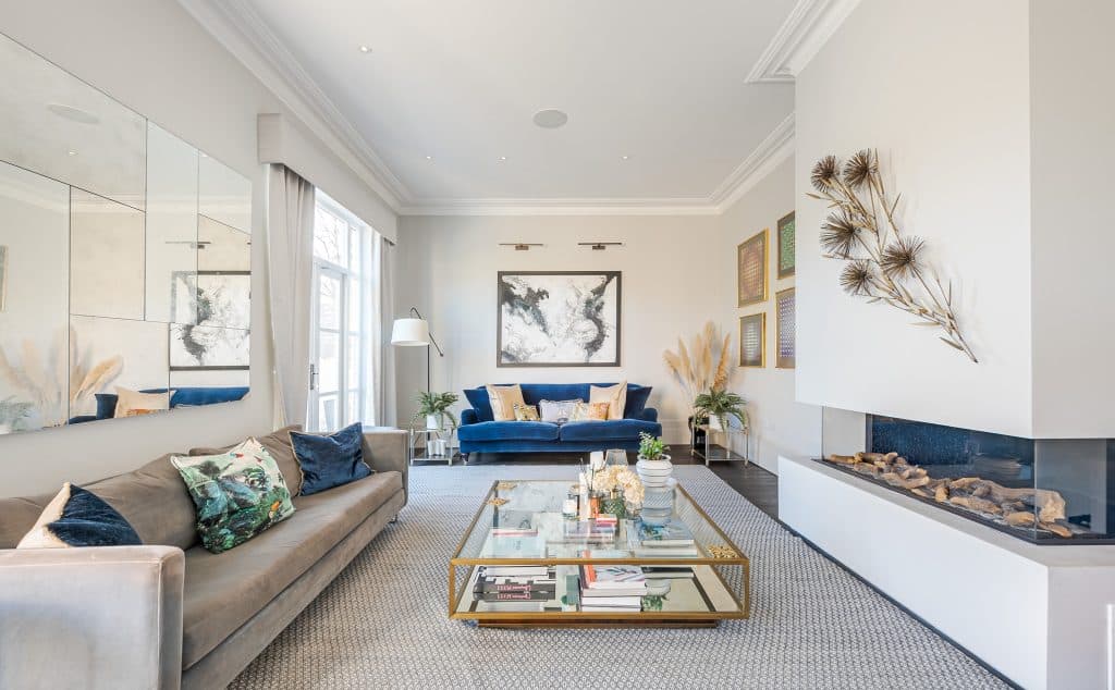 a living room filled with furniture and vase of flowers on a table