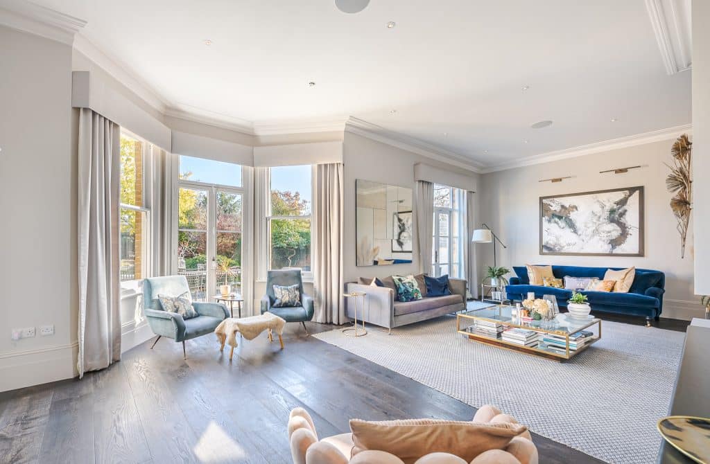 a living room filled with furniture and a large window