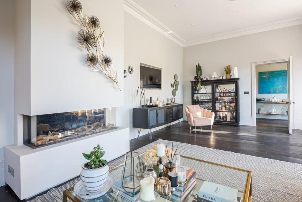 a living room filled with furniture and a fireplace