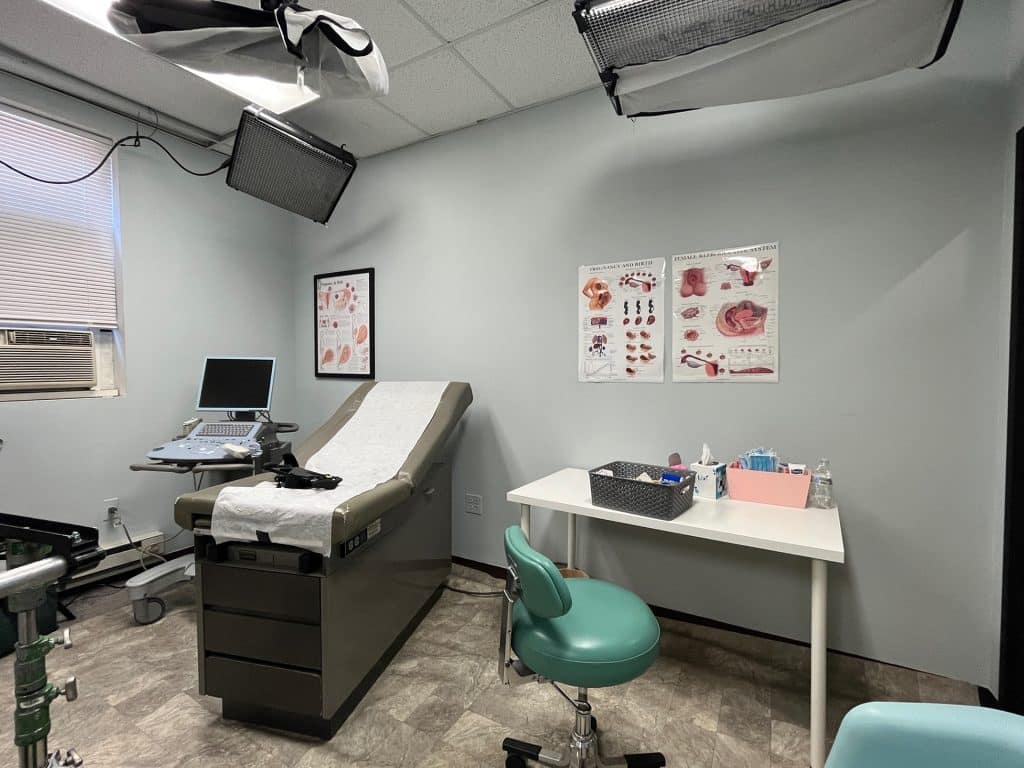 an office with a desk and chair in a room
