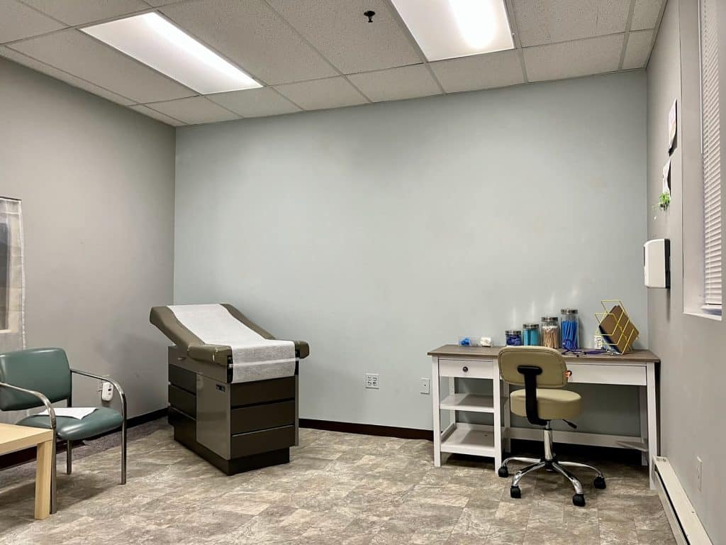 an office with a desk and chair in a room