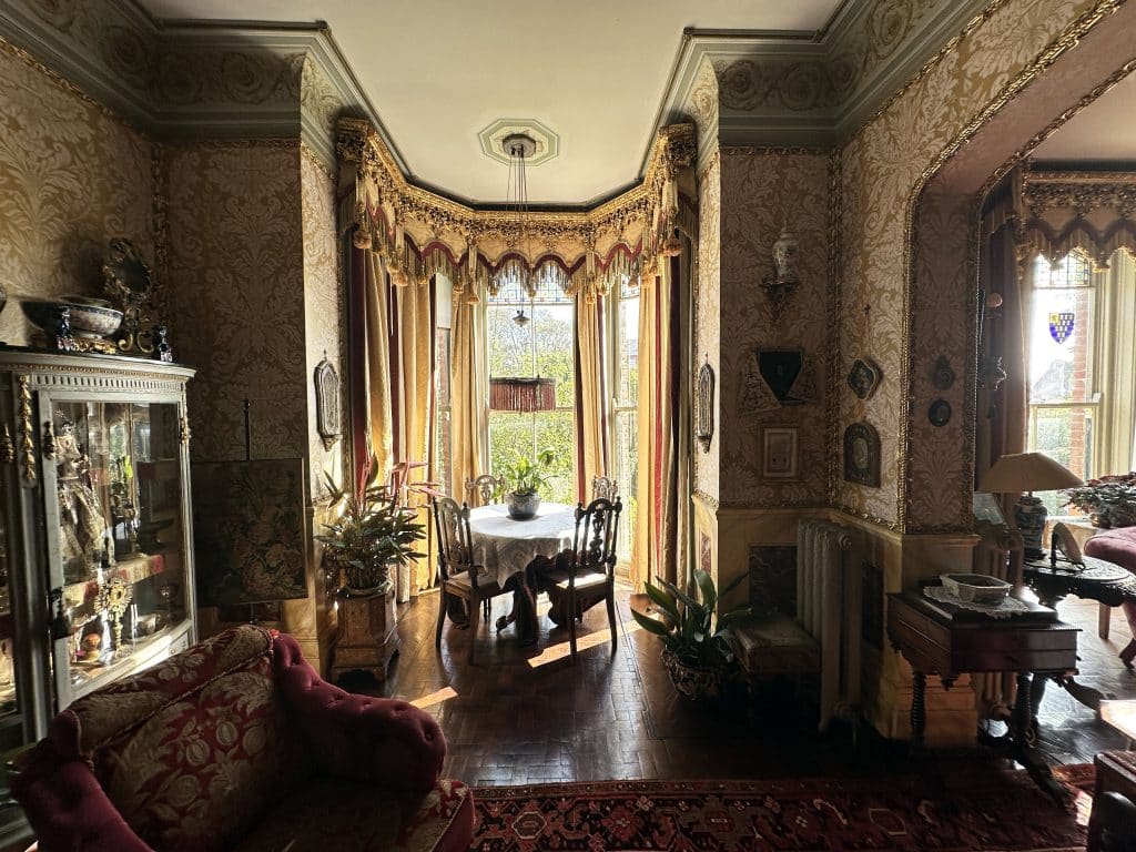 a living room filled with furniture and vase of flowers on a table