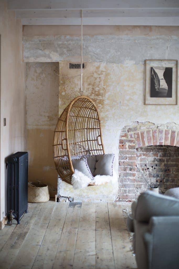 a living room with a stone fireplace