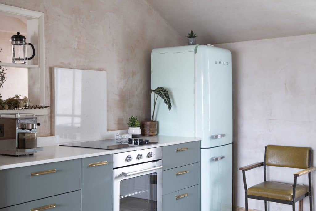 a stove top oven sitting inside of a kitchen
