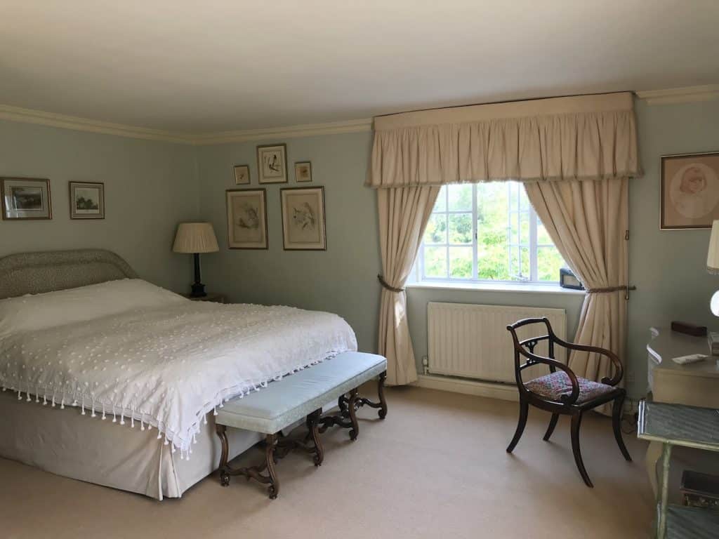 a bedroom with a bed and desk in a room