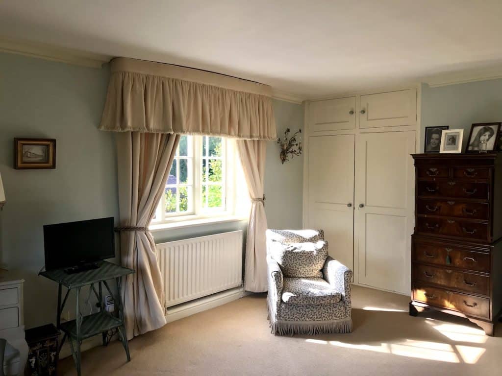 a living room filled with furniture and a large window
