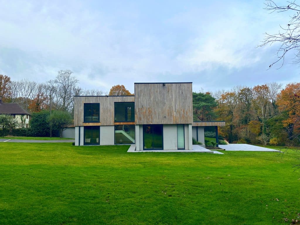 a large green field in front of a house