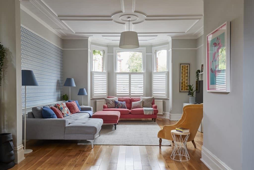 a living room filled with furniture and a large window
