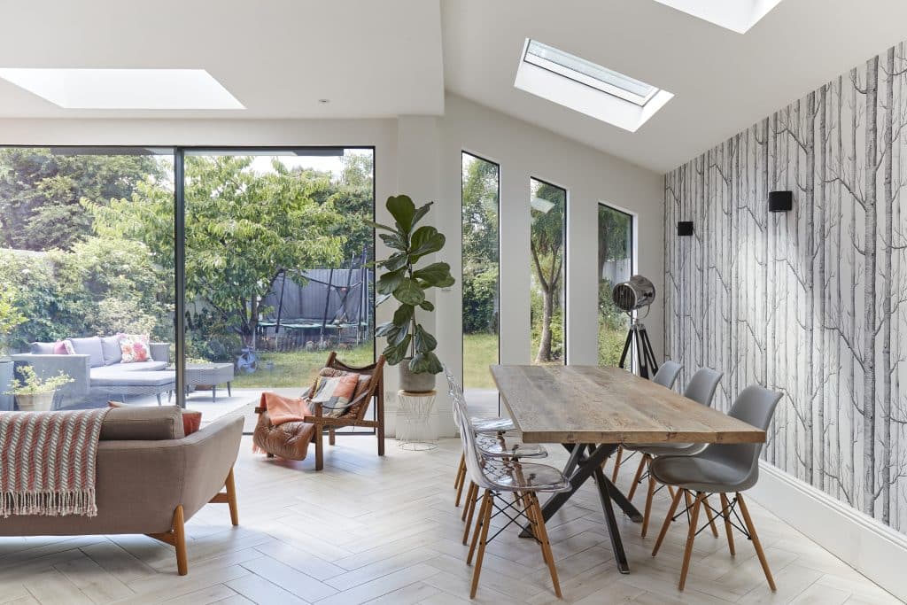 a living room filled with furniture and a large window