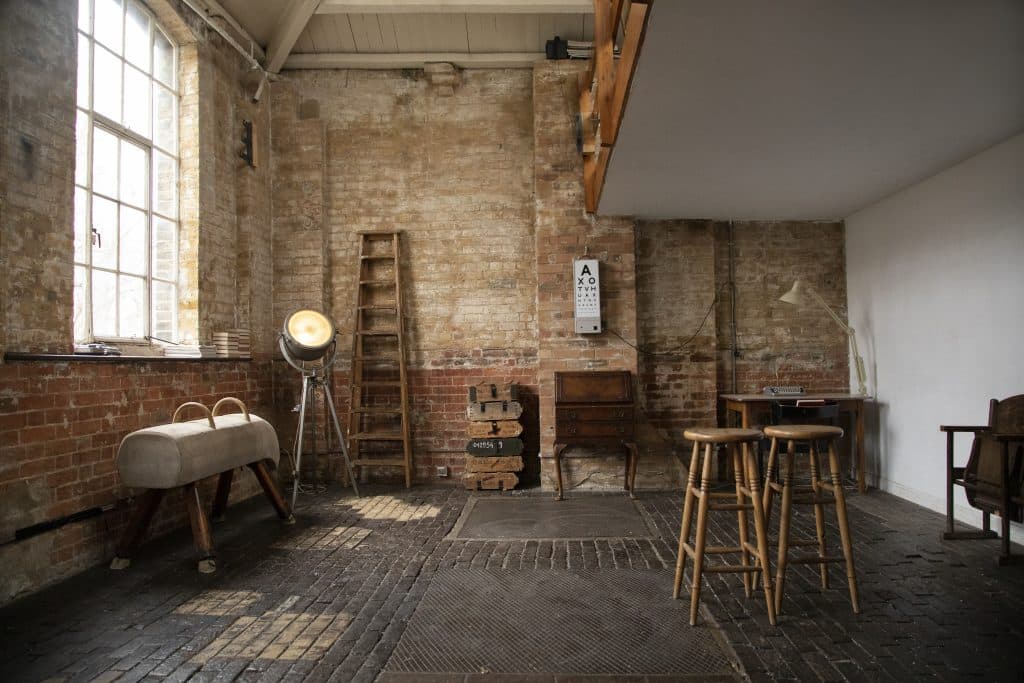 a room filled with furniture and a fire place sitting in a chair