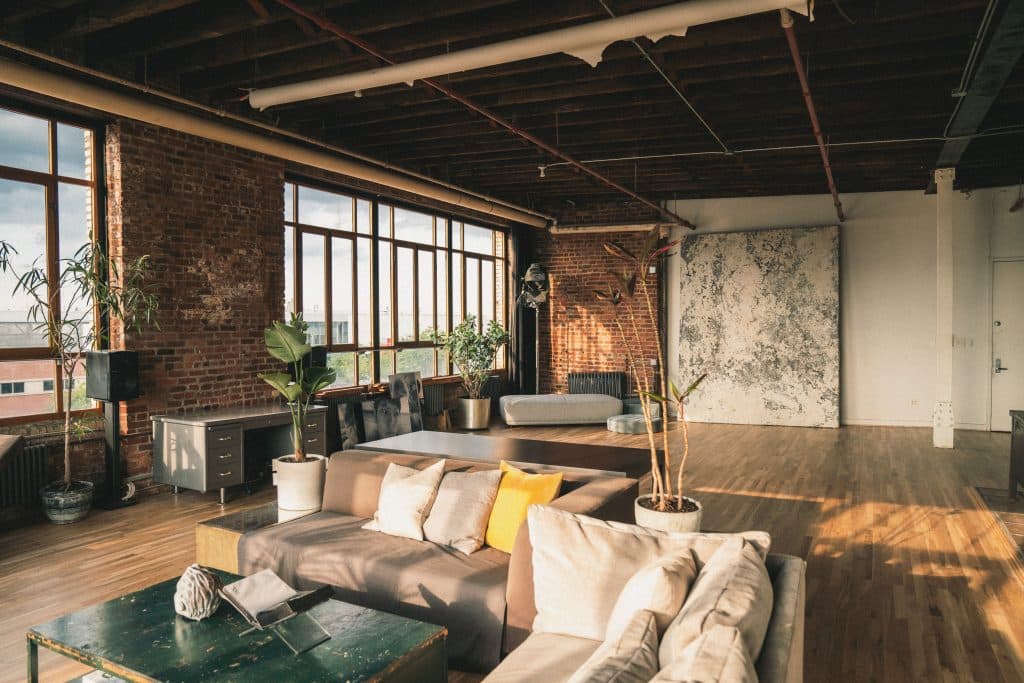 a living room filled with furniture and a large window