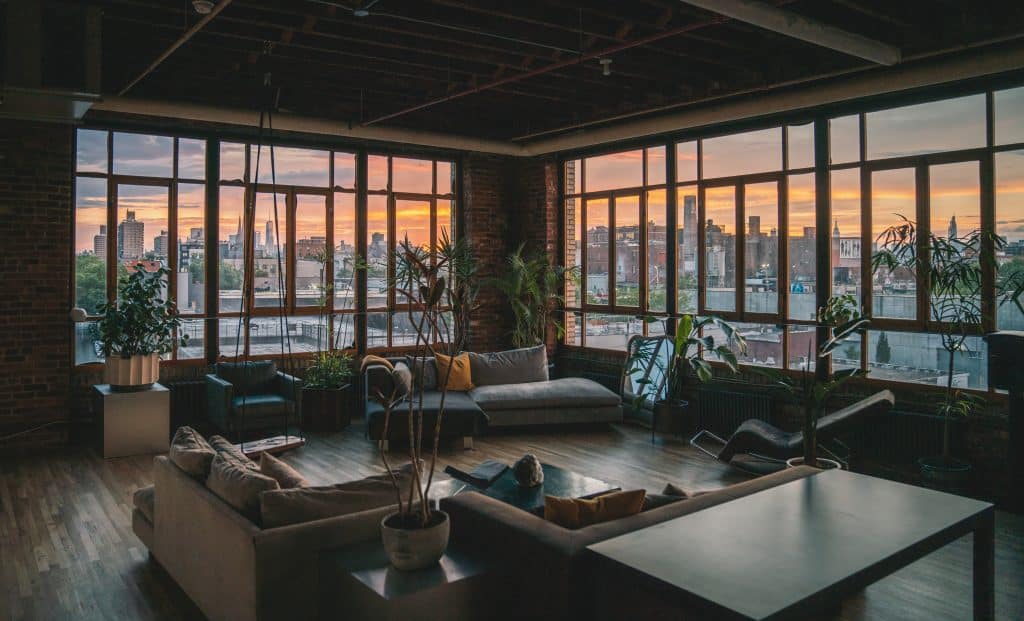 a living room filled with furniture and a large window