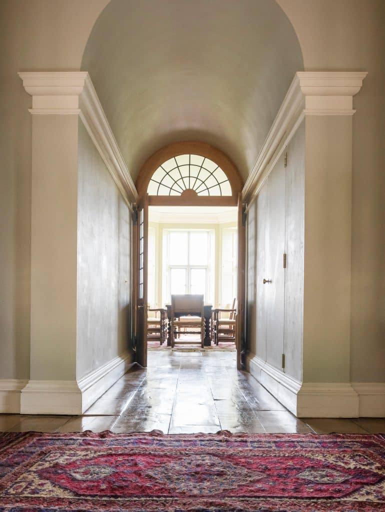 Antique rug in hall leading through to dining room with double doors