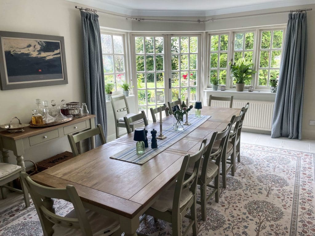 PARK LODGE Dining-room-oak-table-paintings-windows-garden-view-fireplace-cabinet-carpet-TV-filming-location-hire-lodge-London