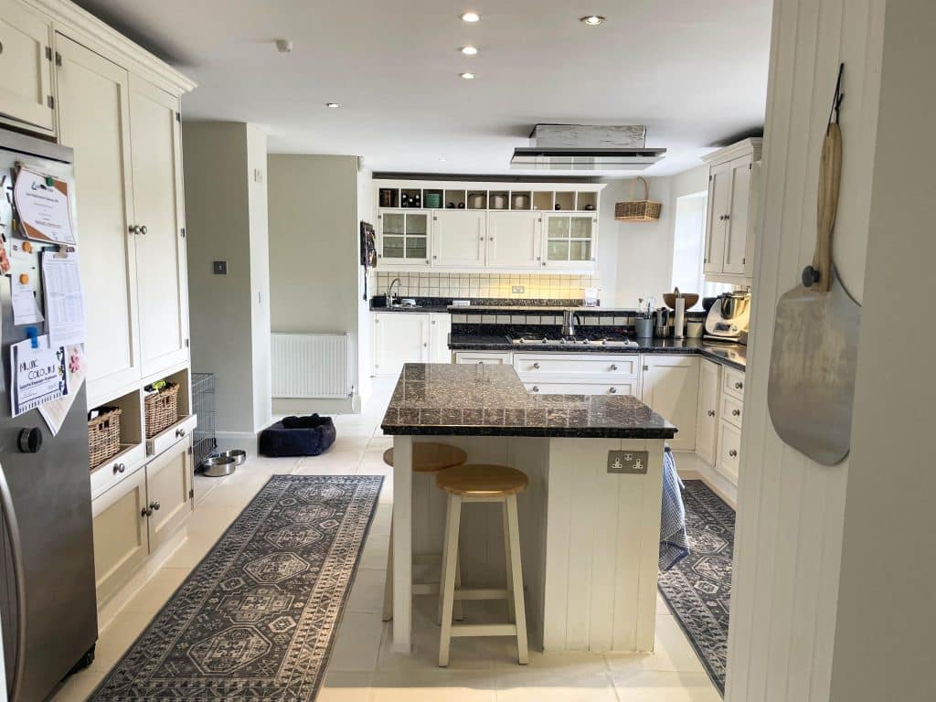 PARK LODGE Kitchen-thru-dining-white-tile-floor-white-cooker-marble-worktops-runner-TV-filming-location-hire-lodge-London